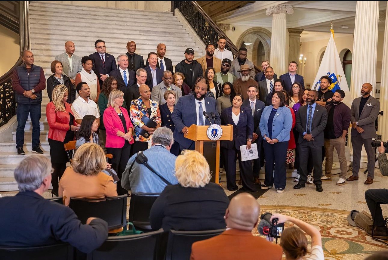 Chris Worrell at the State House podium with supporters